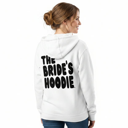 A woman shown from the back wearing a white the APWT Gift Shop's the Bride's Hoodie Premium Zip-Up White Hoodie from the APWT Wedding Shop
