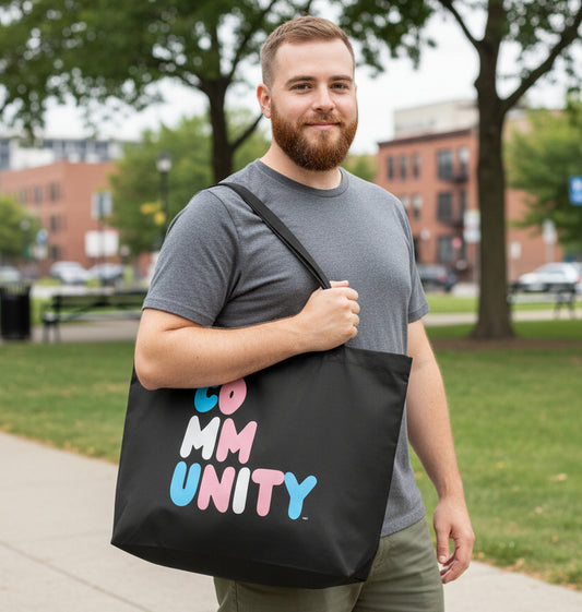 Man wearing the APWT Gift Shop's Be You Community Jumbo Black Tote Bag