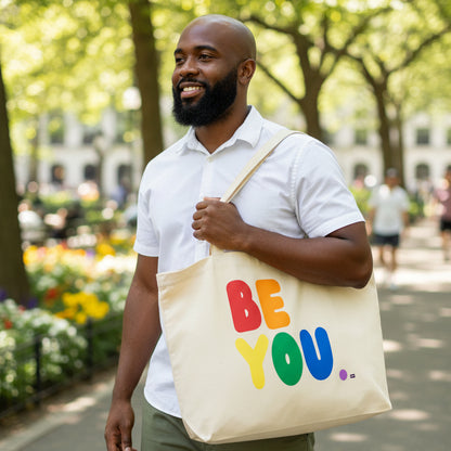 Man wearing a Rainbow Be you Jumbo Tote Bag