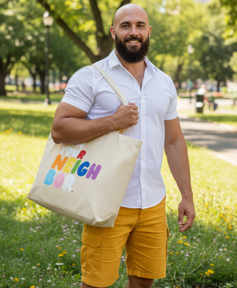Man carrying the I Am Your Neighbor in Color Jumbo Tote Bag from the Pride in the APWT Gift Shop Collection