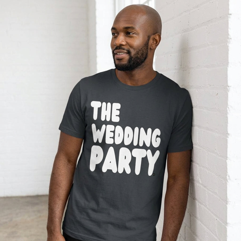 man wearing The Wedding Party Premium Unisex T-Shirt in Dark Grey from the APWT Gift Shop