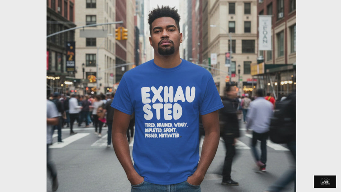 Man standing on a busy city street wearing the APWT Gift Shop's Exhausted in Blue Unisex T-Shirt from the Exhausted Collection