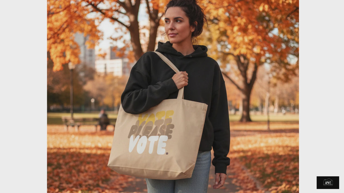 Woman standing in the park carrying the APWT Gift Shop's Please Vote in Yellow Jumbo Tote Bag from the APWT Vote Shop 