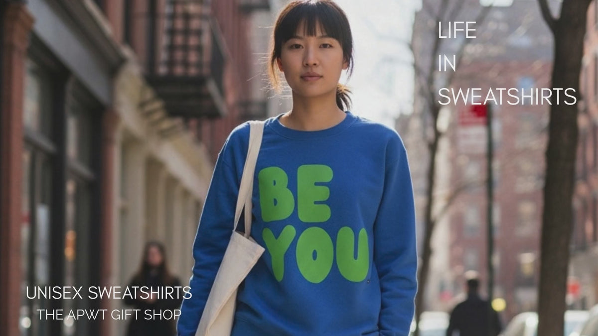 Load video: Woman walking down the street wearing the APWT Gift Shops Be You in Blue and Green Unisex Crew Neck Sweatshirt from the Be You Collection