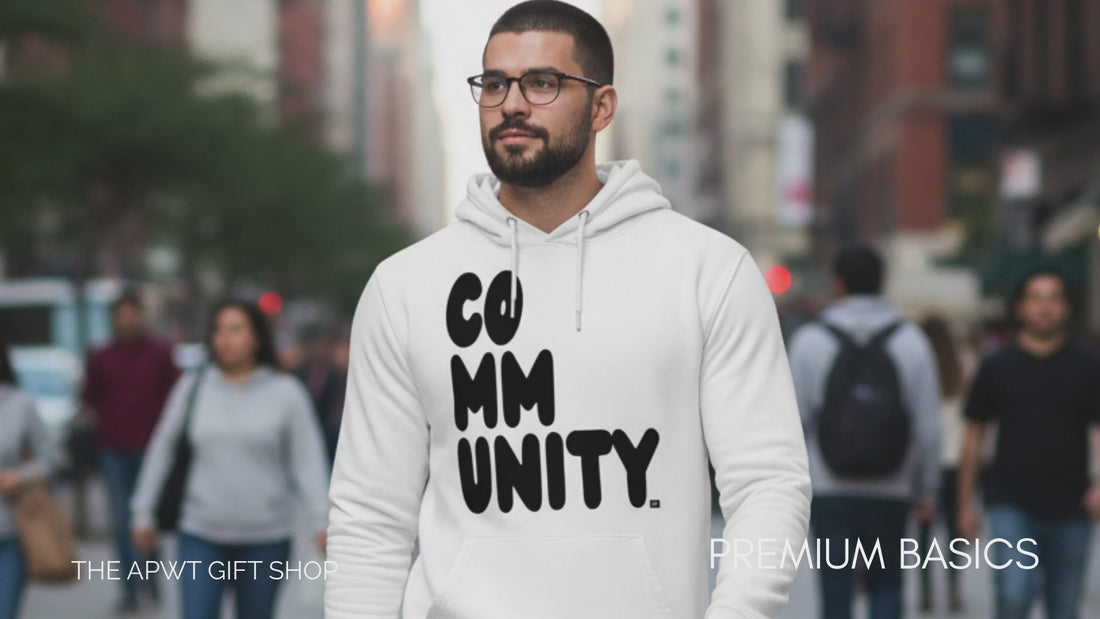 The Premium Basics Collection - Man walking down a city street wearing the APWT Gift Shop's A Community in Black and White Premium Unisex White Hoodie from the Community Collection and the Premium Basics Collection