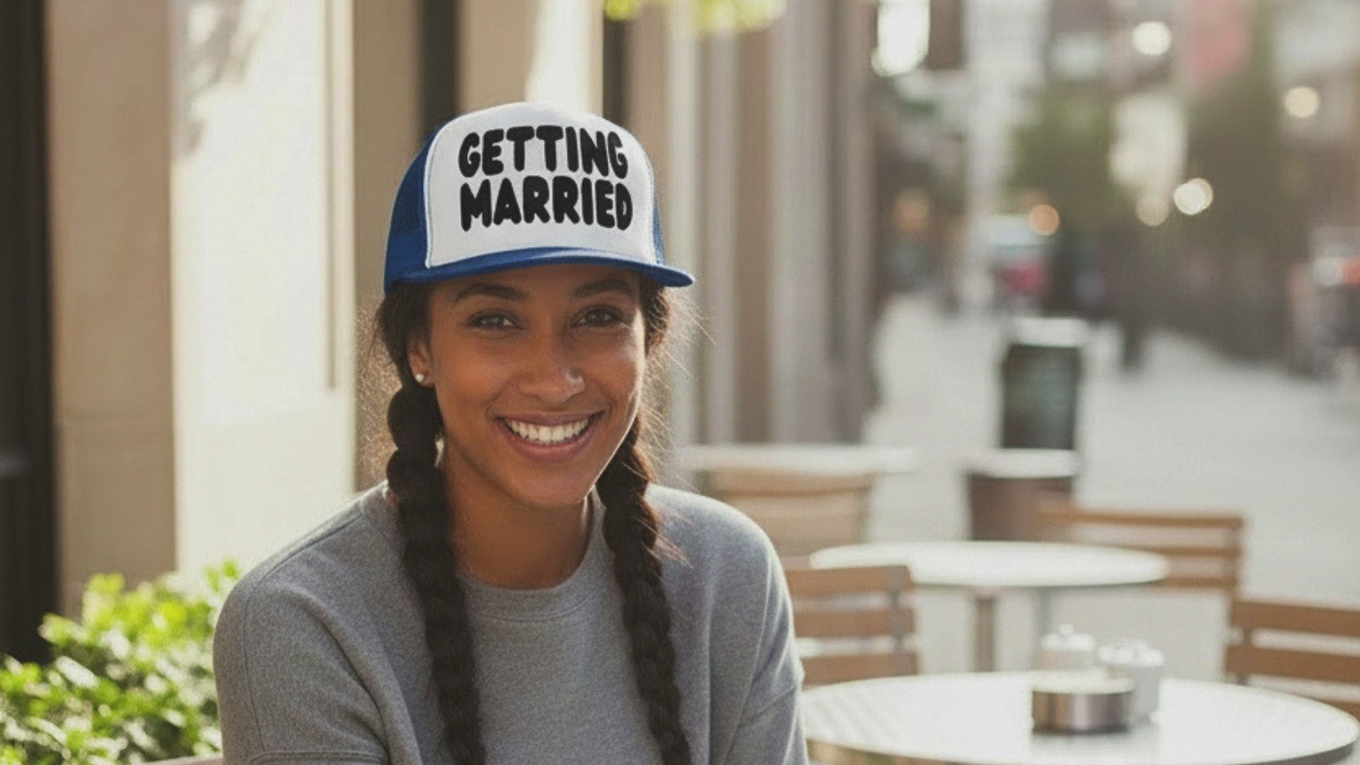 Load video: Woman wearing the APWT Gift Shop's Getting Married Trucker Hat in Royal Blue and White