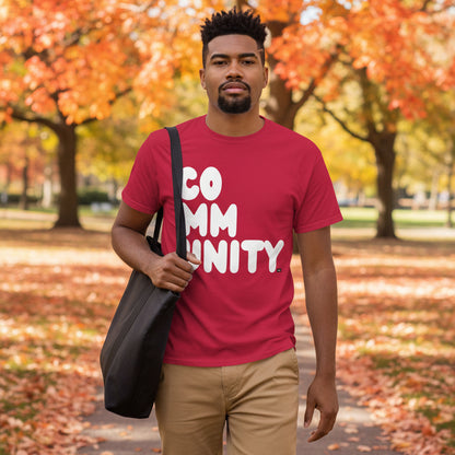 Man walking in the park on an autumn day wearing the APWT Gift Shop's A Community in Apple Red Unisex T-Shirt from the Community Collection