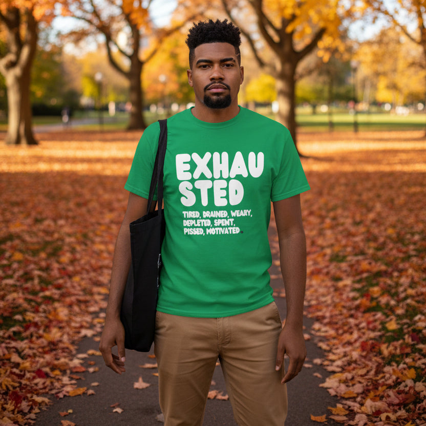 Man standing in the park on an autumn day wearing the APWT Gift Shop's Exhausted in Green Unisex T-Shirt from the Exhausted Collection