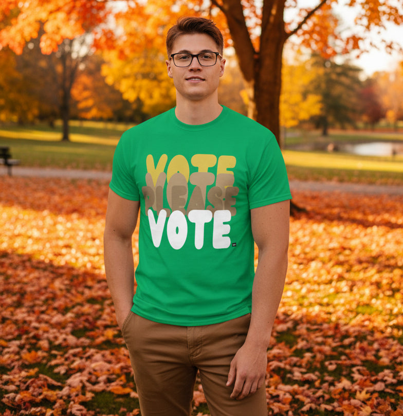 Man standing in the park on an autumn day wearing the APWT Gift Shop's Please Vote in Green Spaces Unisex T-Shirt from the APWT Vote Shop
