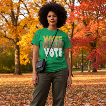 Woman standing in the park on an autumn day wearing the APWT Gift Shop's Please Vote in Green Spaces Unisex T-Shirt from the APWT Vote Shop
