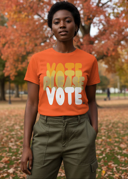 Woman standing in the park on an autumn day wearing the APWT Gift Shop's Please Vote in Safety Cone Orange Unisex T-Shirt from the APWT Vote Shop