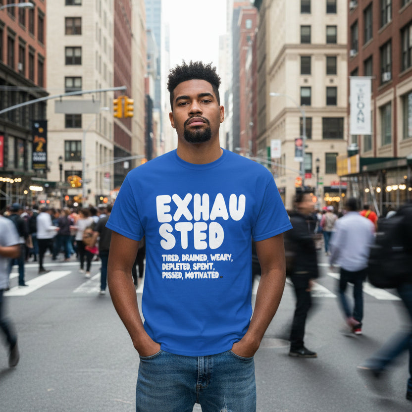 Man standing on a busy city street wearing the APWT Gift Shop's Exhausted in Blue Unisex T-Shirt from the Exhausted Collection