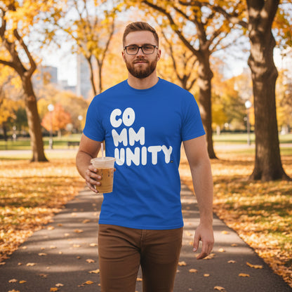 Man walking through the park on an autumn day wearing the APWT Gift Shop's A Community in Ocean Blue Unisex T-shirt from the Community Collection
