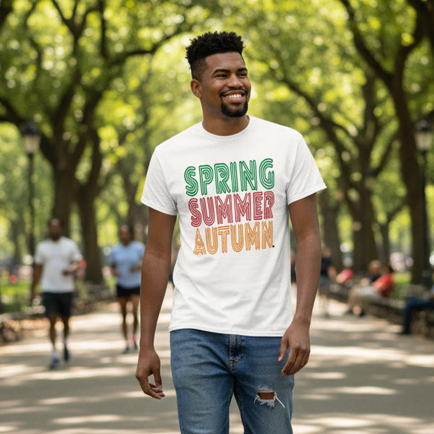 Man walking through a city park wearing the APWT Gift Shop's Spring into Summer Unisex T-Shirt from the Day in the Life Collection