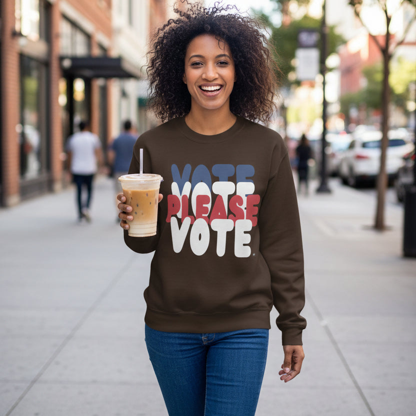 Woman walking down the street wearing The APWT Gift Shop's Please Vote Unisex Crew Neck Sweatshirt from the APWT Vote Shop in Brown