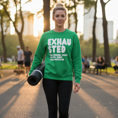 Woman walking through a city park carrying a yoga mat wearing the APWT Gift Shop's Exhausted in Green Unisex Crew Neck Sweatshirt from the Exhausted Collection