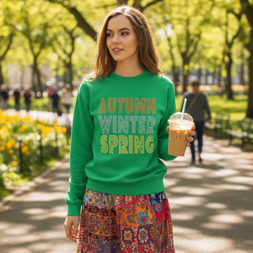 Woman walking through the park wearing the APWT Gift Shop's Fall in Autumn Unisex Crew Neck Sweatshirt from the Day in the Life Collection in Green