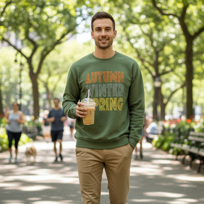 Man walking through the park wearing the APWT Gift Shop's Fall in Autumn Unisex Crew Neck Sweatshirt from the Day in the Life Collection in Olive Green
