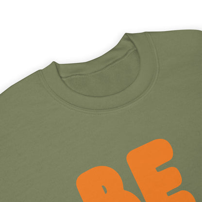 The APWT Gift Shop's Be You in Olive Green and Orange Unisex Crew Neck Sweatshirt from the Be You Collection's neckline