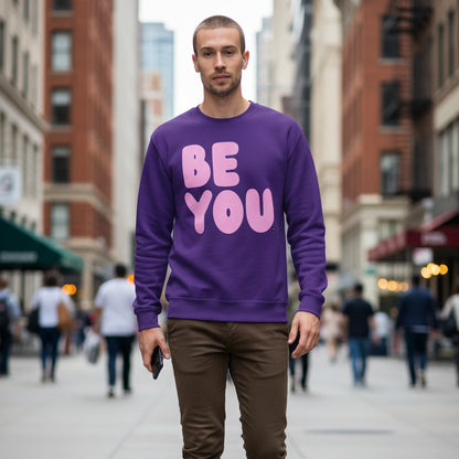 Man walking down the street wearing The APWT Gift Shop's Be You in Purple and Pink Unisex Crew Neck Sweatshirt from the Be You Collection 
