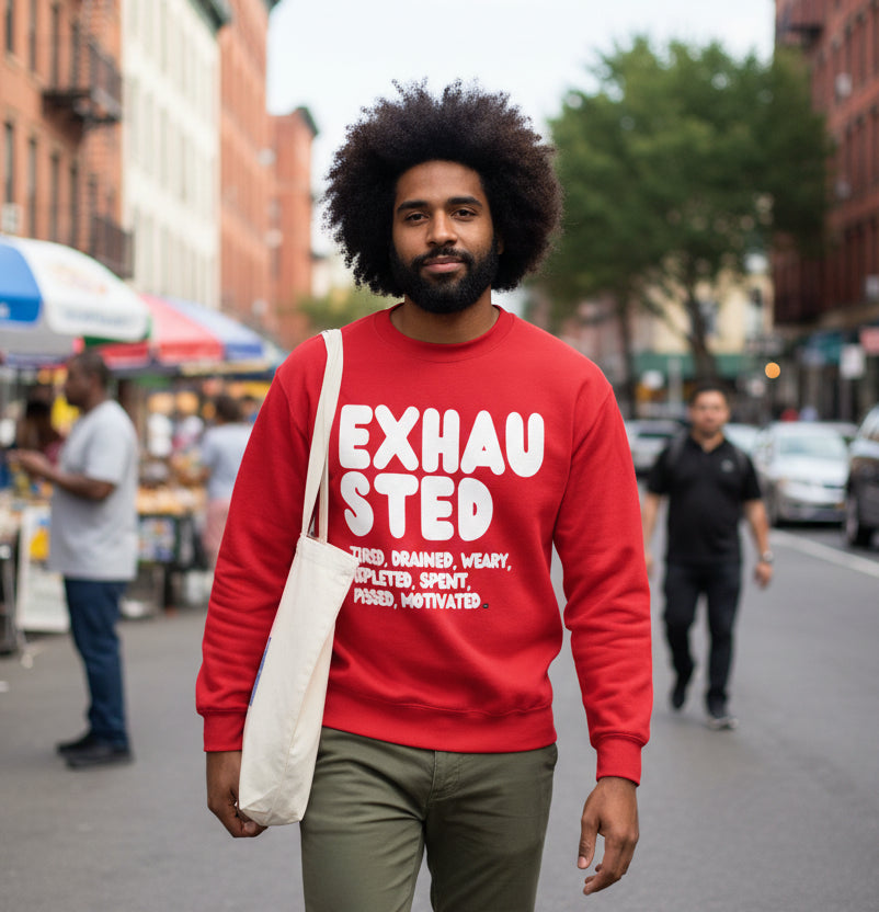 Man walking down a city street wearing the APWT Gift Shop's Exhausted in Red Unisex Crew Neck Sweatshirt from the Exhausted Collection