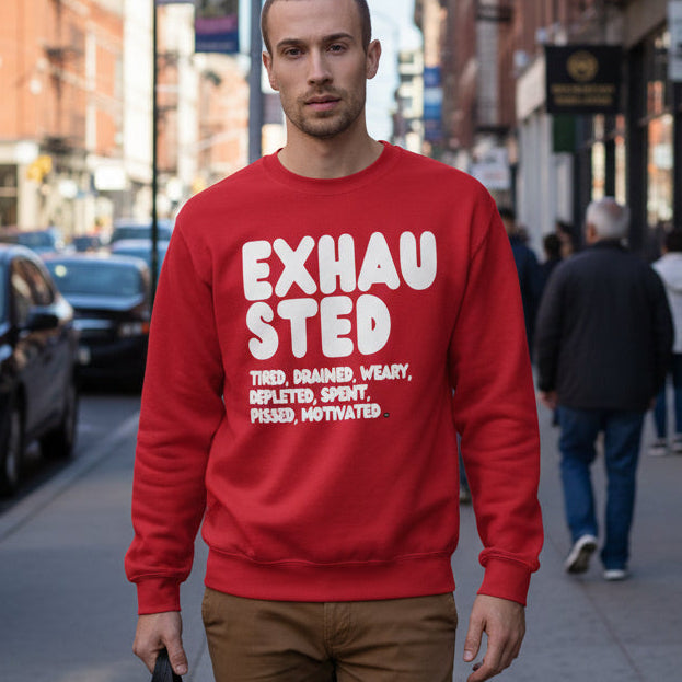 Man walking down a city street wearing the APWT Gift Shop's Exhausted in Red Unisex Crew Neck Sweatshirt from the Exhausted Collection