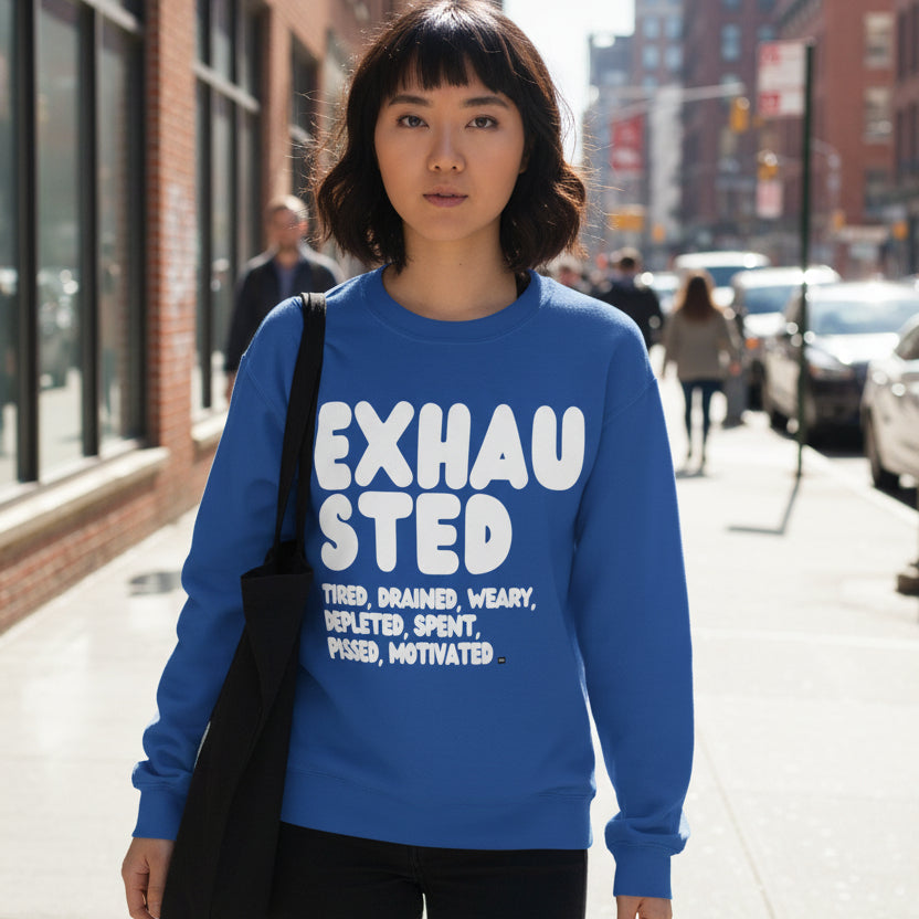 Woman walking down a city street wearing the APWT Gift Shop's Exhausted in Blue Unisex Crew Neck Sweatshirt from the Exhausted Collection