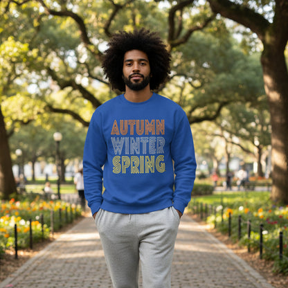Man walking through the park wearing the APWT Gift Shop's Fall in Autumn Unisex Crew Neck Sweatshirt from the Day in the Life Collection in Royal Blue