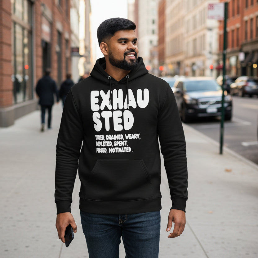 Man wearing the APWT Gift Shop's Exhausted in Black and White Premium Unisex Hoodie from the Exhausted Collection and the Premium Basics Collection