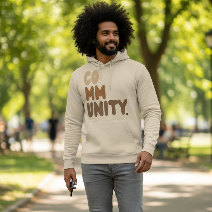 Man wearing The APWT Gift Shop's Our Community Premium Unisex Hoodie from the Community Collection and the Premium Basics Collection in Beige