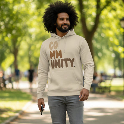 Man wearing The APWT Gift Shop's Our Community Premium Unisex Hoodie from the Community Collection and the Premium Basics Collection in Beige