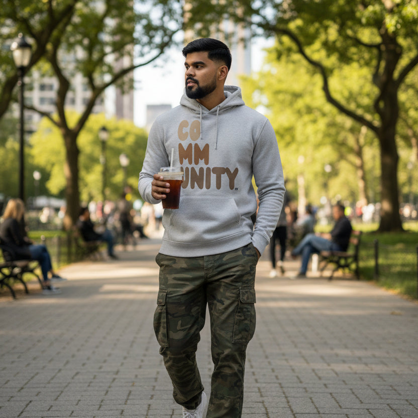 Man wearing The APWT Gift Shop's Our Community Premium Unisex Hoodie from the Community Collection and the Premium Basics Collection in Grey