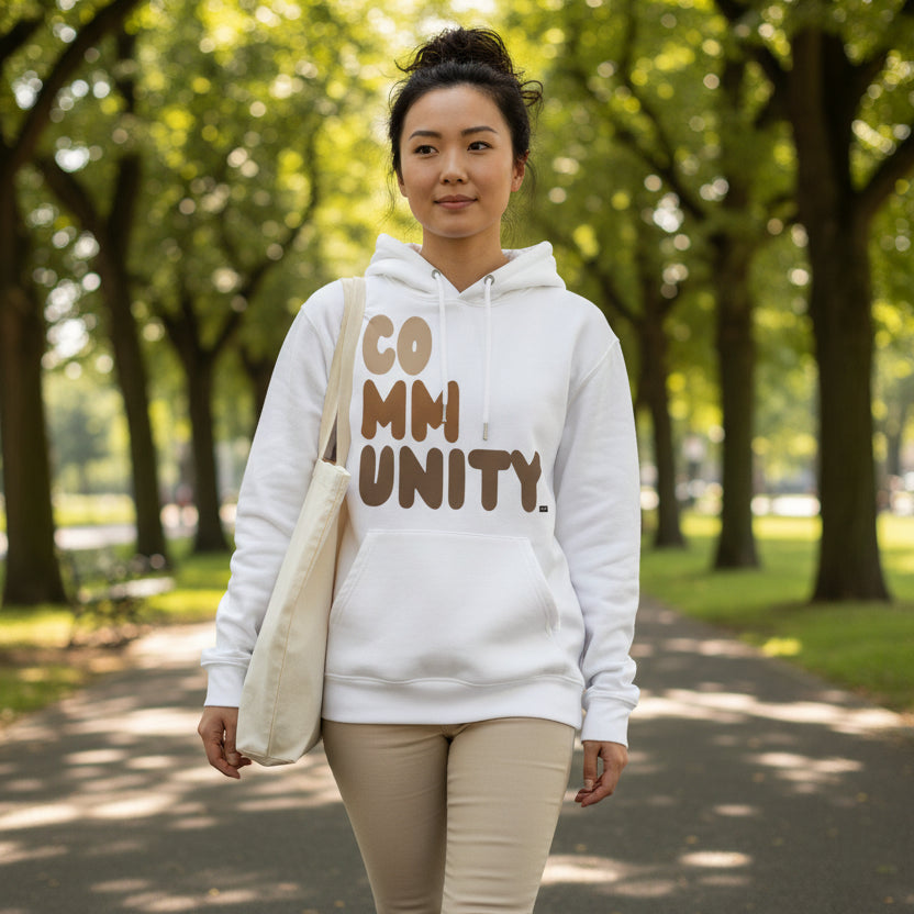 Woman wearing The APWT Gift Shop's Our Community Premium Unisex Hoodie from the Community Collection and the Premium Basics Collection in White