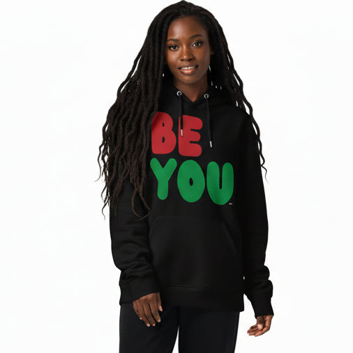 Woman wearing the APWT Gift Shop's Be You in Black Premium Unisex Hoodie from the Black Collection