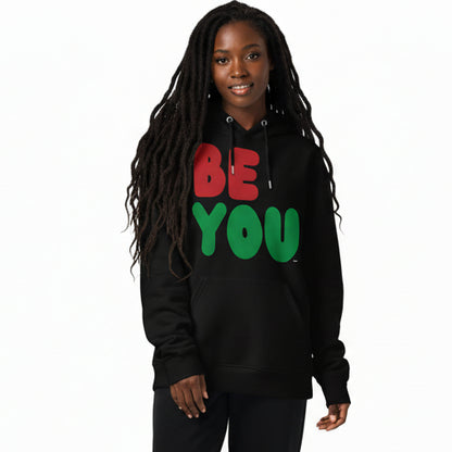 Woman wearing the APWT Gift Shop's Be You in Black Premium Unisex Hoodie from the Black Collection