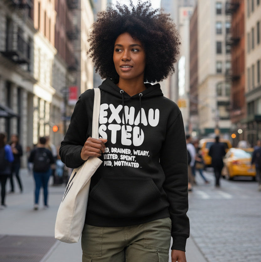 Woman wearing the APWT Gift Shop's Exhausted in Black and White Premium Unisex Hoodie from the Exhausted Collection and the Premium Basics Collection