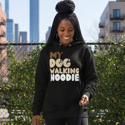 Woman standing on a city street wearing the APWT Gift Shop's My Dog Walking Hoodie Premium Unisex Hoodie from the Day in the Life Collection in Black