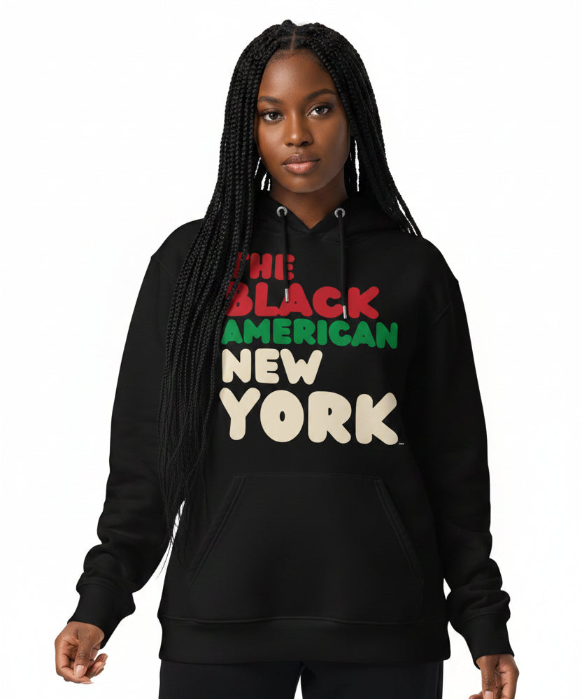 Woman wearing the APWT Gift Shop's The Black American New York Premium Unisex Hoodie from the Black Collection and the Premium Basics Collection