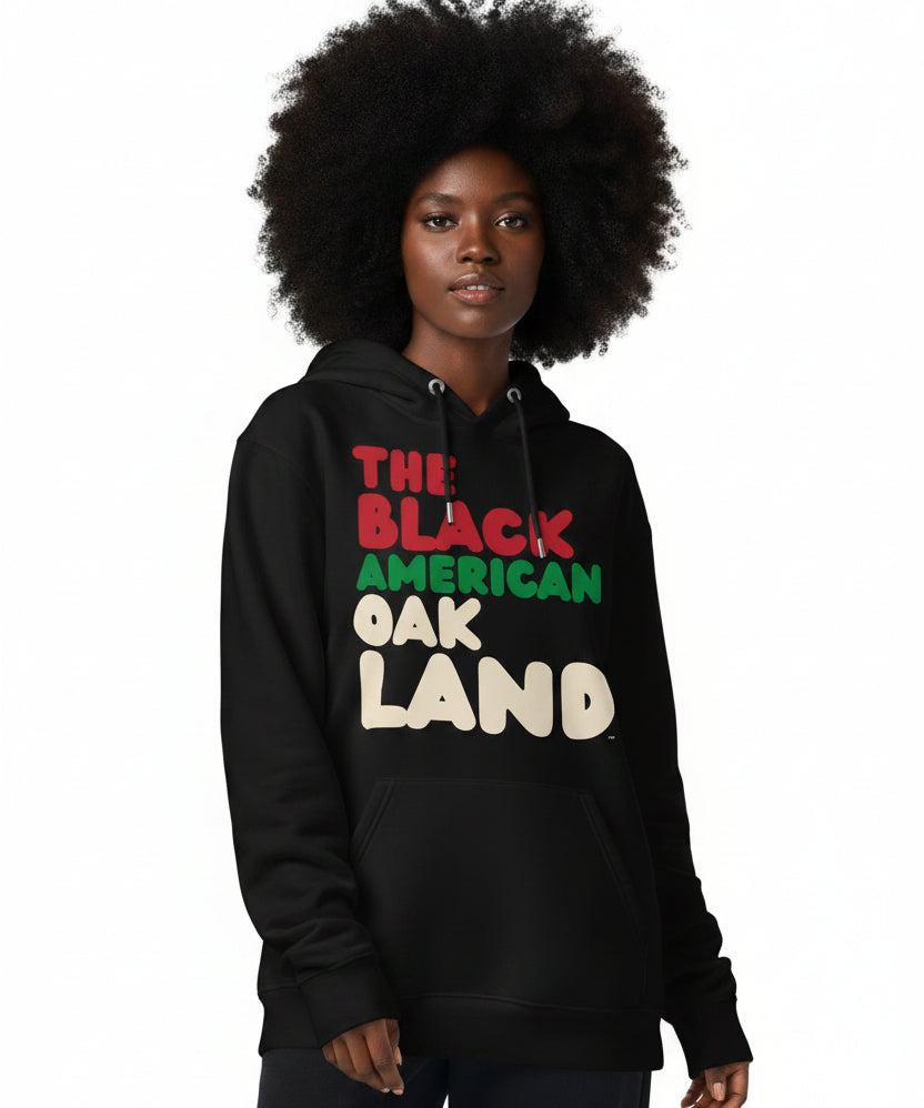 Woman wearing the APWT Gift Shop's the Black American Oakland Premium Unisex Hoodie from the Black Collection