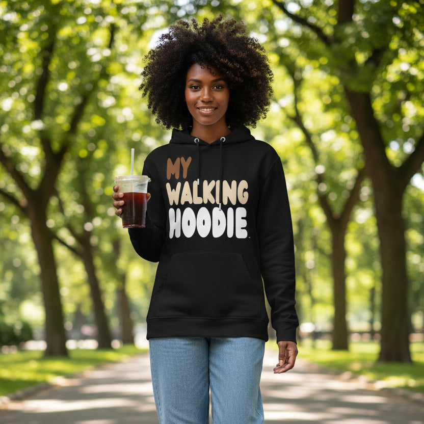 Woman walking down a city street wearing the APWT Gift Shop's My Walking Hoodie Premium Unisex Hoodie from the Day in the Life Collection in Black