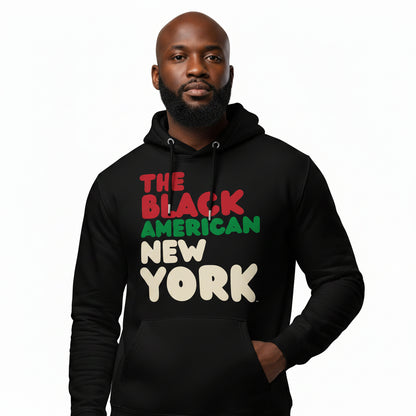 Man wearing the APWT Gift Shop's the Black American New York Premium Unisex Hoodie from the Black Collection