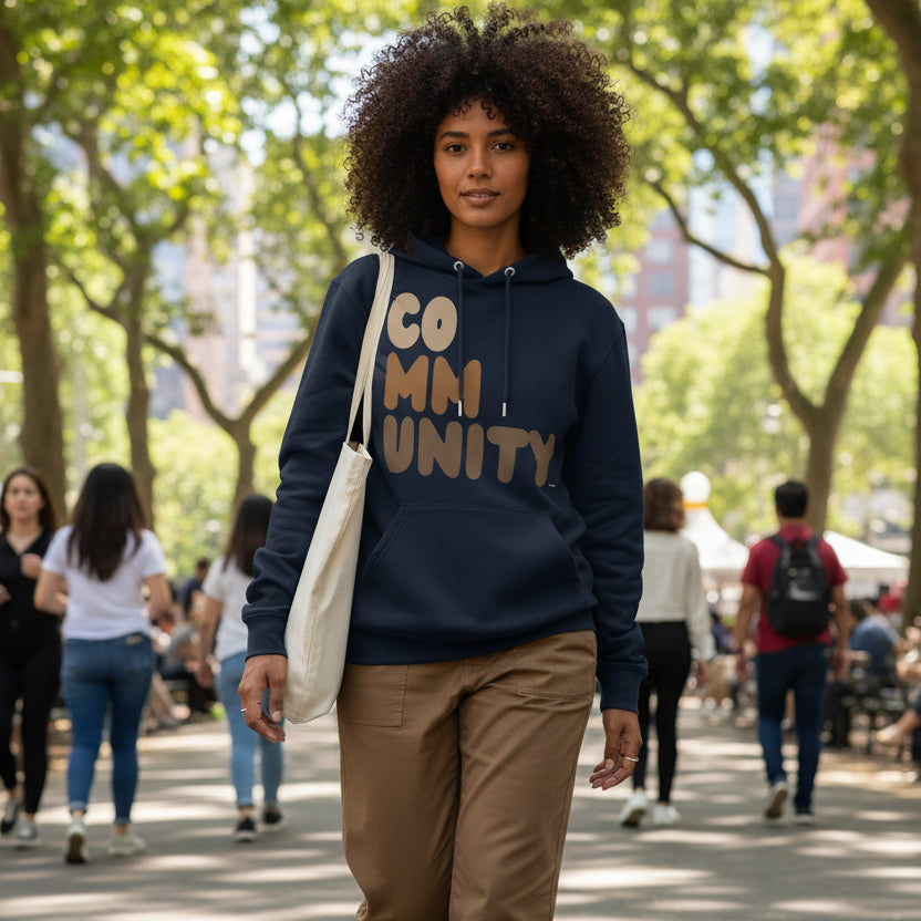 Woman wearing The APWT Gift Shop's Our Community Premium Unisex Hoodie from the Community Collection and the Premium Basics Collection in Navy Blue