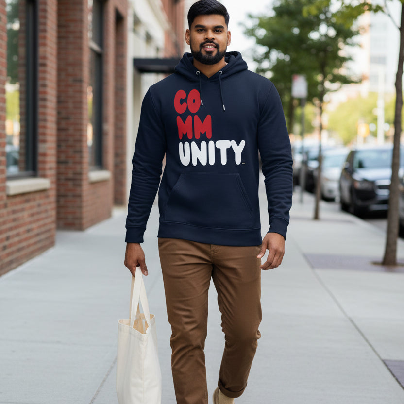 Man walking down a city sidewalk wearing the APWT Gift Shop's Community Fracture Premium Unisex Hoodie from the Community Collection and the Premium Basics Collection