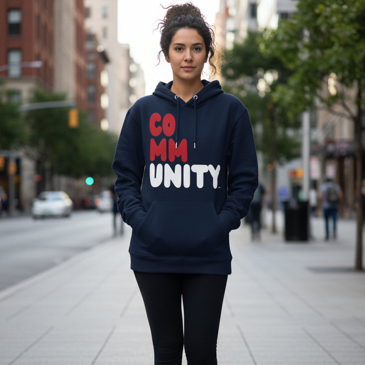 Woman walking down a city sidewalk wearing the APWT Gift Shop's Community Fracture Premium Unisex Hoodie from the Community Collection and the Premium Basics Collection
