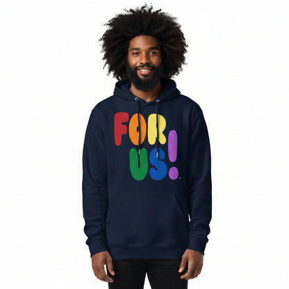 Man wearing the APWT Gift Shop's Rainbow For Us Premium Unisex Hoodie featuring the 'For Us' message in the colors of the LGBTQ+ Pride Flag