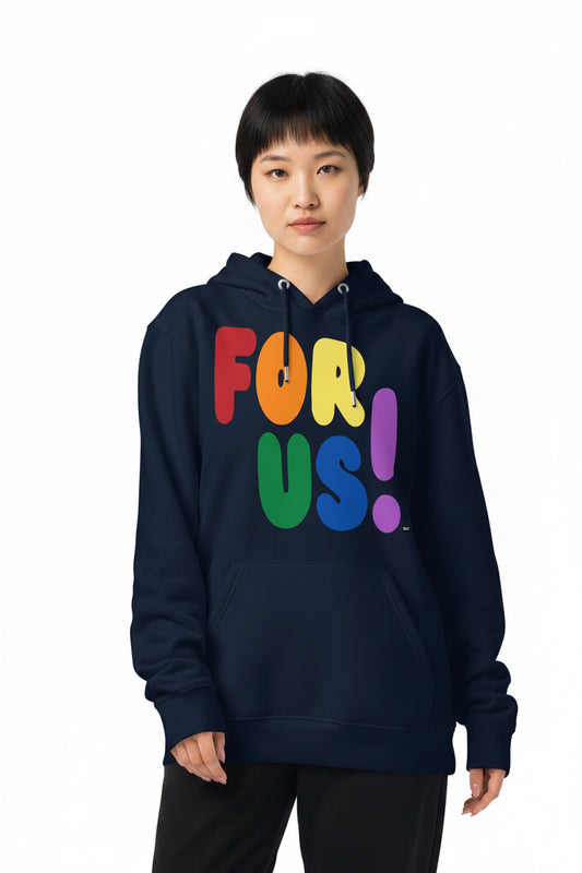 Woman wearing the APWT Gift Shop's Rainbow For Us Premium Unisex Hoodie featuring the 'For Us' message in the colors of the LGBTQ+ Pride Flag
