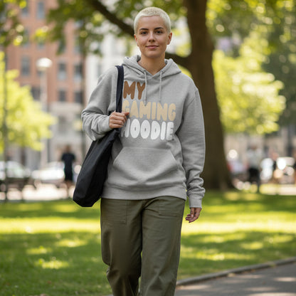 Woman walking through city park wearing the APWT Gift Shop's My Gaming Hoodie Premium Unisex Hoodie from the Day in the Life Collection in Grey