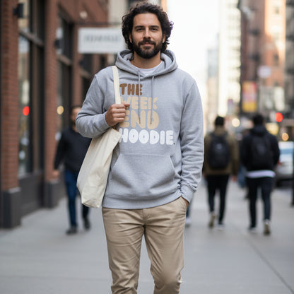 Man walking down a city street wearing the APWT Gift Shop's The Weekend Hoodie Premium Unisex Hoodie from the Day in the Life Collection and the Premium Basics Collection in a grey