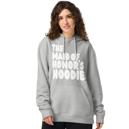 Woman wearing the APWT Gift Shop's Maid of Honor's Hoodie Premium Unisex Hoodie from the APWT Wedding Shop in Grey