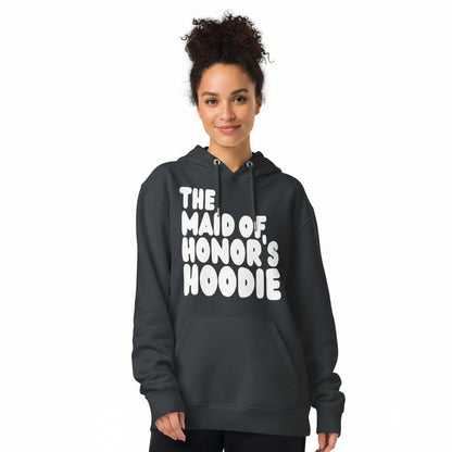 Woman wearing the APWT Gift Shop's Maid of Honor's Hoodie Premium Unisex Hoodie from the APWT Wedding Shop in Charcoal Grey